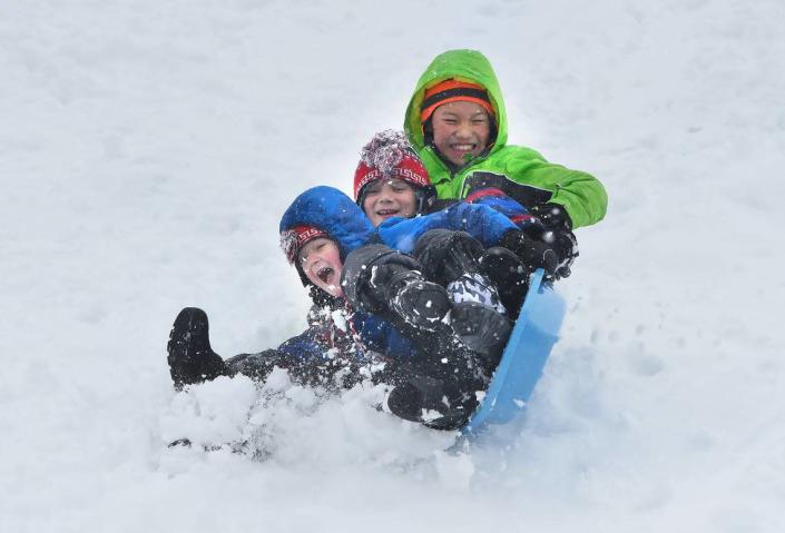 Sledders prepare for a topsy-turvy end to their ride on a hill in Durham in 2018. Forecasters call for 3-5 inches across the Triangle this weekend.