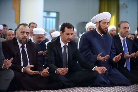 Syria's President Bashar al-Assad (2nd L) attends Eid al-Adha prayers at al-Nu'man bin Bashir mosque in Damascus October 4, 2014, in this handout photograph released by Syria's national news agency SANA. REUTERS/SANA/Handout via Reuters