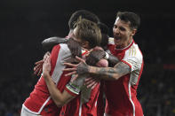 Arsenal's Martin Odegaard, center, celebrates with teammates after scoring his side's second goal during the English Premier League soccer match between Wolverhampton Wanderers and Arsenal at the Molineux Stadium in Wolverhampton, England, Saturday, April 20, 2024. (AP Photo/Rui Vieira)