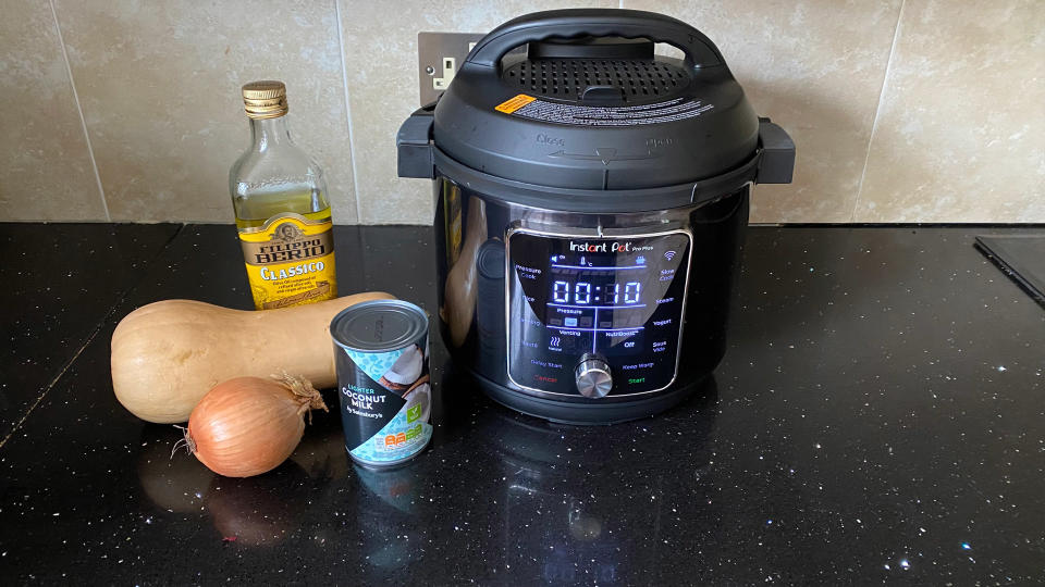  The Instant Pot Pro Plus Smart Multi-Cooker and some ingredients on a kitchen counter. 