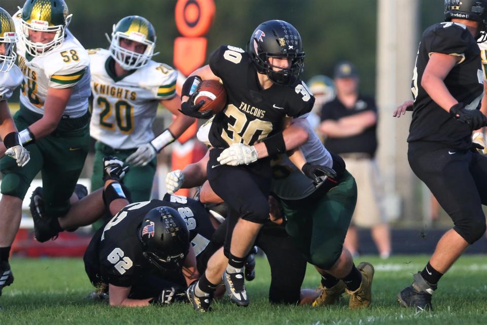 Winchester's Aidan Weatherhead breaks a tackle in the team's game against Northeastern at Winchester High School on Friday, Sept. 2, 2022.