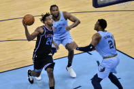 Sacramento Kings guard Buddy Hield (24) drives against Memphis Grizzlies forward Justise Winslow (7) and center Xavier Tillman (2) in the second half of an NBA basketball game Friday, May 14, 2021, in Memphis, Tenn. (AP Photo/Brandon Dill)