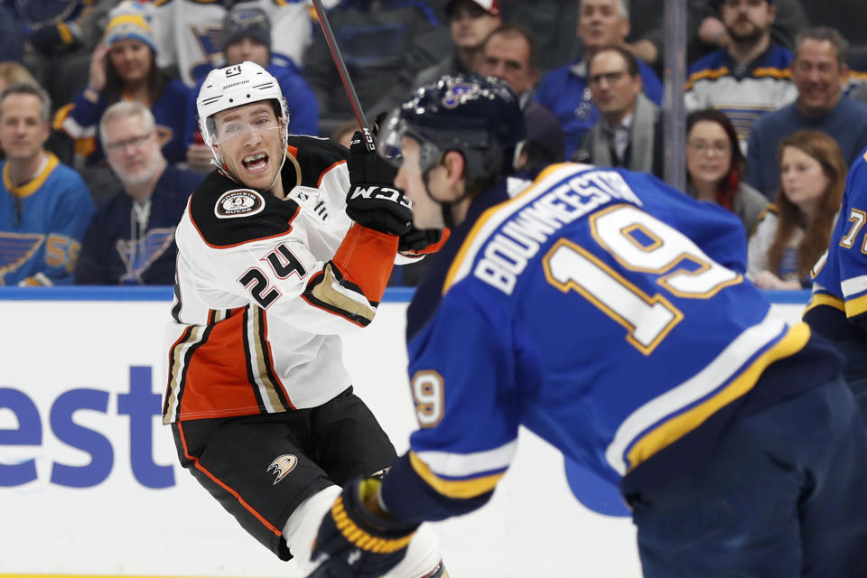 St. Louis Blues' Jay Bouwmeester (19) handles the puck as Anaheim Ducks' Carter Rowney (24) defends during the first period of an NHL hockey game Monday, Jan. 13, 2020, in St. Louis. (AP Photo/Jeff Roberson)