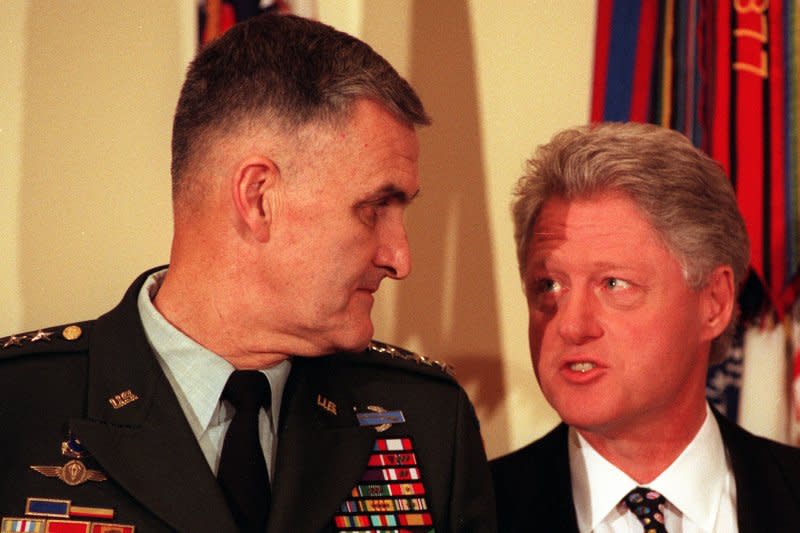 President Clinton speaks to Joint Chiefs Chairman Gen. Hugh Shelton during a brief press conference and announcement with reporters on the refugee crisis in Kosovo and the release of two suspects by Libya to be tried for the Pan Am flight 103 bombing over Lockerbie, Scotland, April 5, 1999 in the White House Roosevelt Room. File Photo by Ian Wagreich/UPI