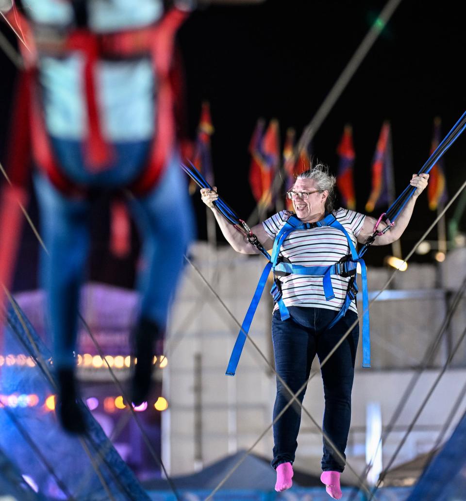 Addie Simmons of Orange cove bobs on the Euro Bungy on Thursday, September 14, 2023. It was her first time at the fair. Thousands attended the second day of the Tulare County Fair for free carnival rides included with paid admission in partnership with Helm & Sons Amusements.