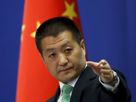 Chinese Foreign Ministry spokesman Lu Kang points out a reporter to receive a question at a regular news conference in Beijing, October 27, 2015. REUTERS/Kim Kyung-Hoon