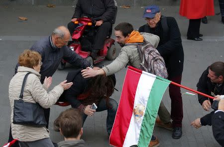 Pro- and anti-government supporters scuffle near a ceremony marking the 60th anniversary of 1956 anti-Communist uprising in Budapest, Hungary, October 23, 2016. REUTERS/Laszlo Balogh