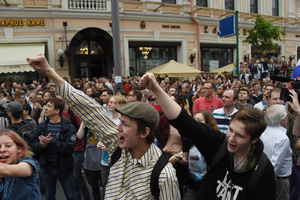 People chant slogans during an unauthorized opposition rally in Moscow.