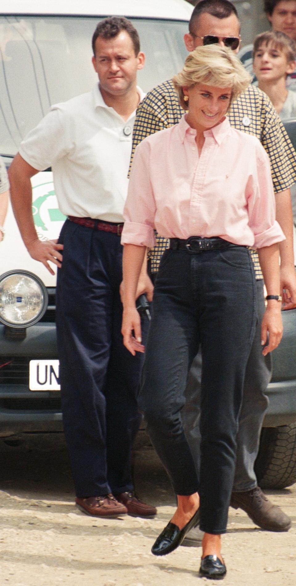 Paul Burrell (left, in the background in the white shirt and black trousers, butler to Diana, Princess of Wales as she makes a three day visit to Bosnia - Herzegovina as part of her campaign to raise awareness about the devastating effects landmines have on peoples lives and to call for a complete ban on the production, sale and use of land mines. The trip was organised by the American-based Landmine Survivors Network. Picture taken 10th August 1997. (Photo by Kent Gavin/Mirrorpix/Getty Images)