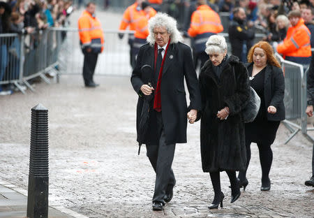 Musician Brian May and actor Anita Dobson arrive at Great St Marys Church, where the funeral of theoretical physicist Prof Stephen Hawking is being held, in Cambridge, Britain, March 31, 2018. REUTERS/Henry Nicholls