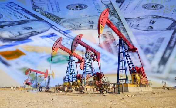 Oil pumps with money in the background.