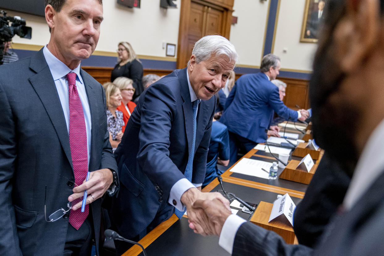 JPMorgan Chase & Co. Chairman and CEO Jamie Dimon, center, accompanied by PNC Financial Services Group Chairman, President, and CEO William Demchak, left, greets members of congress as he appears before a House Committee on Financial Services Committee hearing on 