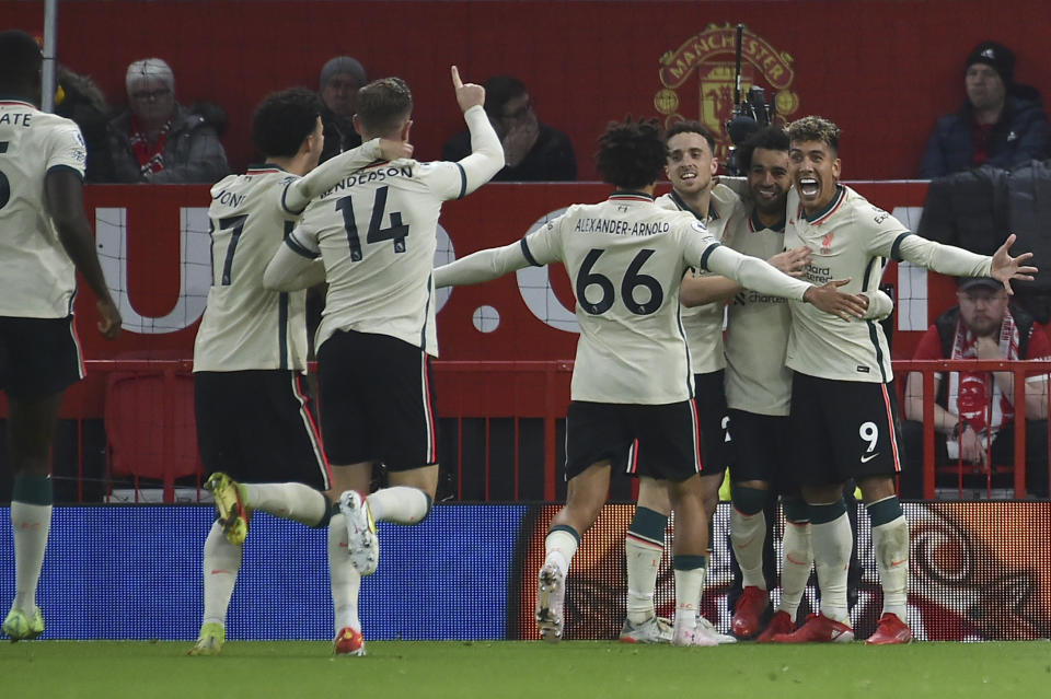 Liverpool's Mohamed Salah, 2nd right, celebrates after scoring his side's fifth goal during the English Premier League soccer match between Manchester United and Liverpool at Old Trafford in Manchester, England, Sunday, Oct. 24, 2021. (AP Photo/Rui Vieira)