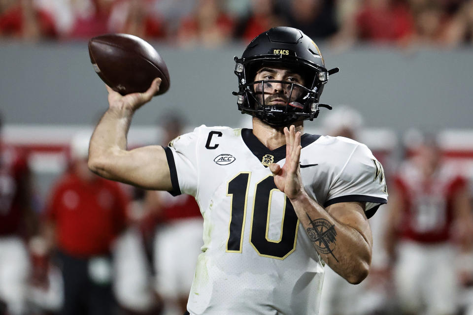 Wake Forest quarterback Sam Hartman (10) throws the ball against North Carolina State during the first half of an NCAA college football game in Raleigh, N.C., Saturday, Nov. 5, 2022. (AP Photo/Karl B DeBlaker)