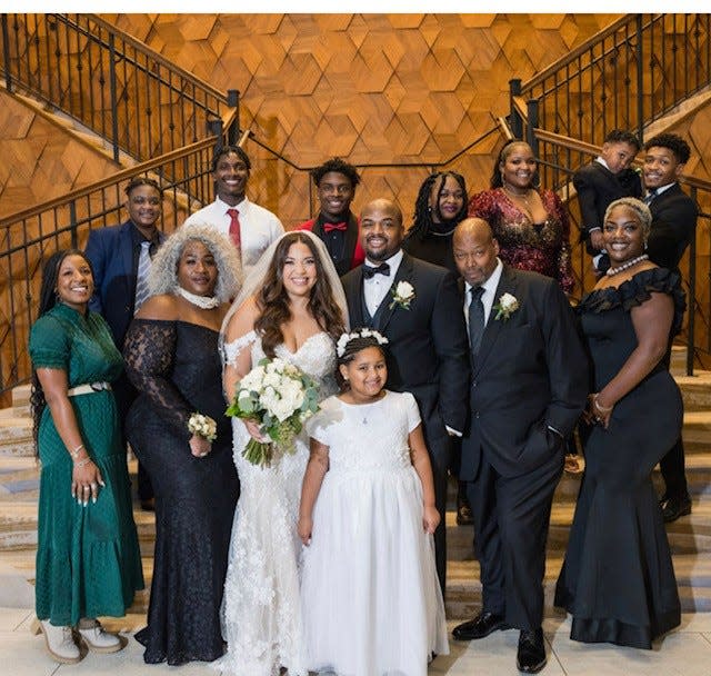 The Major's family at the wedding of son Corey Majors in 2022.. From left to right Kirrye. Devon, Christopher, Colin, Cayla, Dominque, her fiance Haneef Tucker holding their son Kollin-Kash. Corey is to the right of his father, Dwayne, and Cinquetta is to the left.  Tyronda Majors is to the left of the bride.  In the front is Londyn Majors. Missing in the photos are siblings Dwayne and Courtney.