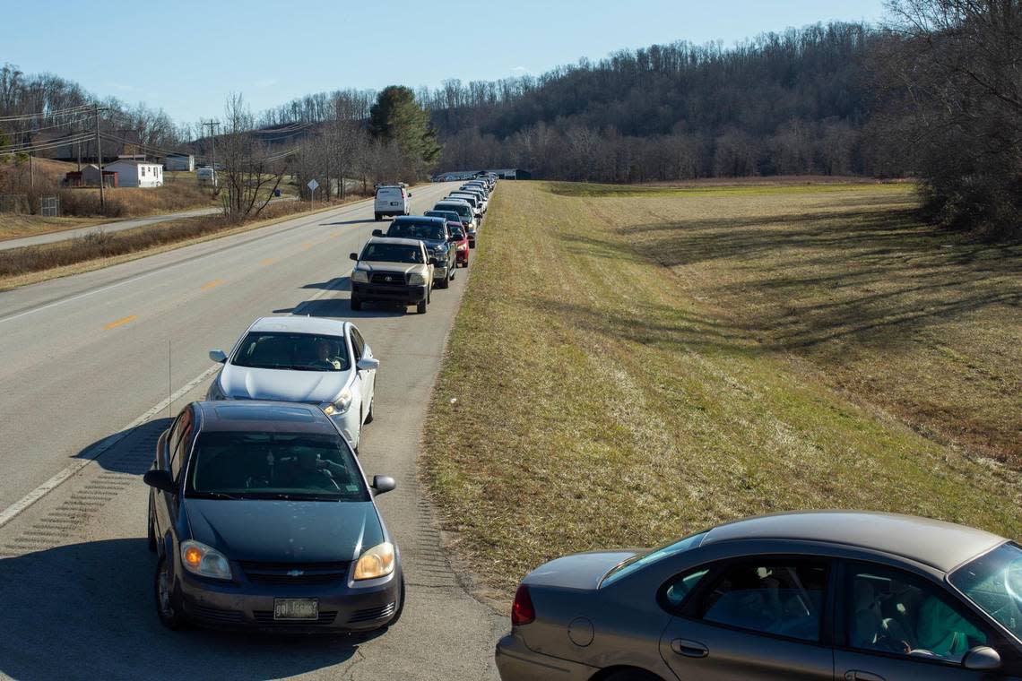 People line up to receive hot meals, food supplies and water from volunteers with Mercy Chefs and the Hazel Green Food project outside at the Hazel Green Food Project in Wolfe County, Ky., Thursday, January 19, 2023. Silas Walker/swalker@herald-leader.com