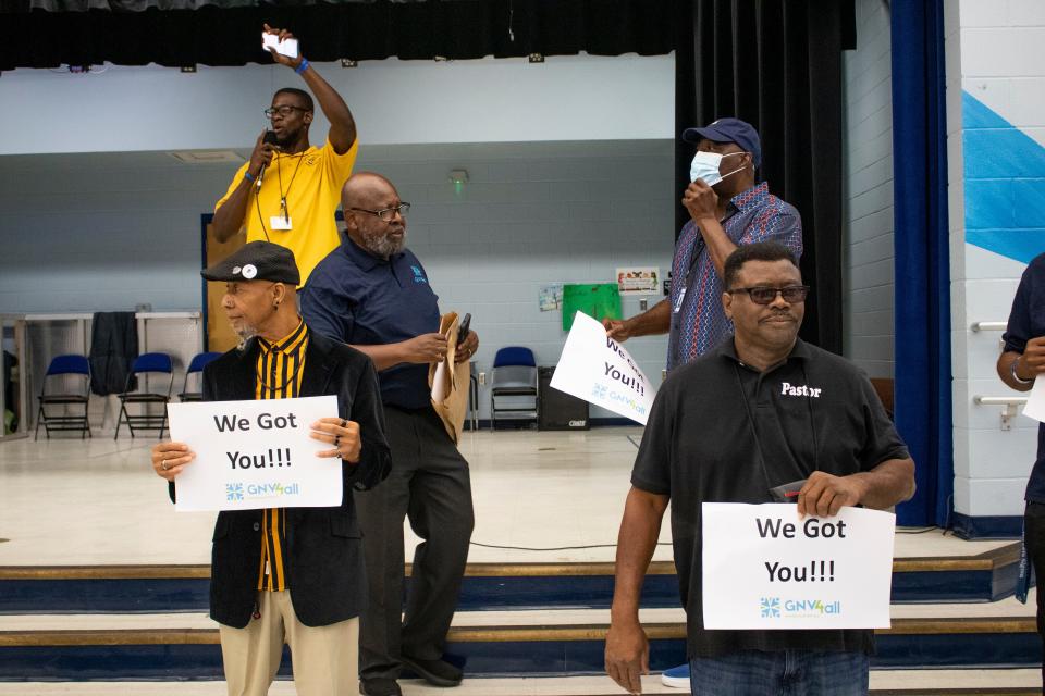 Dads and community members gather on stage Thursday at Rawlings Elementary School to speak in front of students during the father cheering event organized by the Fatherhood Initiative of Gainesville For All in Gainesville before students took the math part of the Florida Student Assessment end-of-year exam.