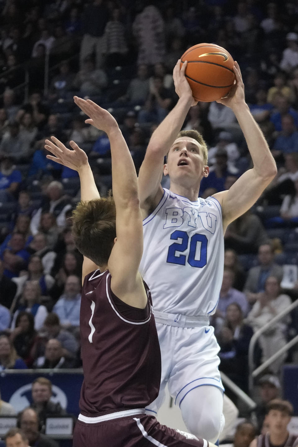 BYU guard Spencer Johnson (20) shoots as Bellarmine guard Landin Hacker (1) defends during the first half of an NCAA college basketball game Friday, Dec. 22, 2023, in Provo, Utah. (AP Photo/Rick Bowmer)