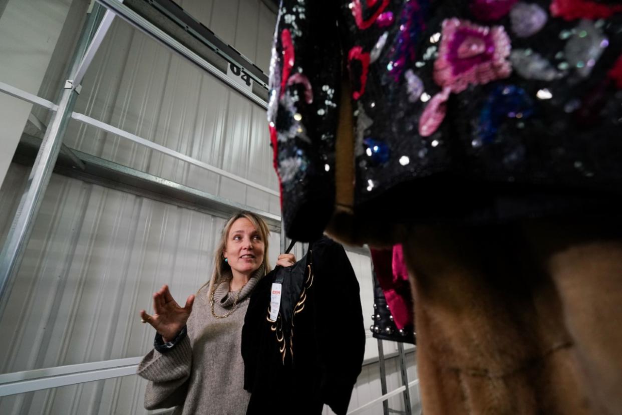 Stylist Bay Garnett has a look through her fashion show items (Jacob King/PA)