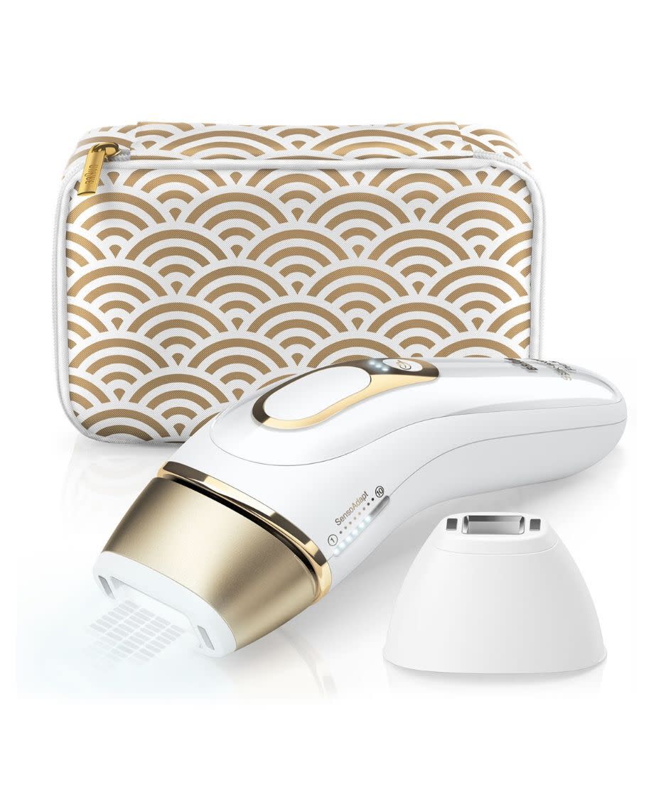 a white and gold Braun Silk Expert Pro 5 IPL device next to its white and gold zip carry case.
