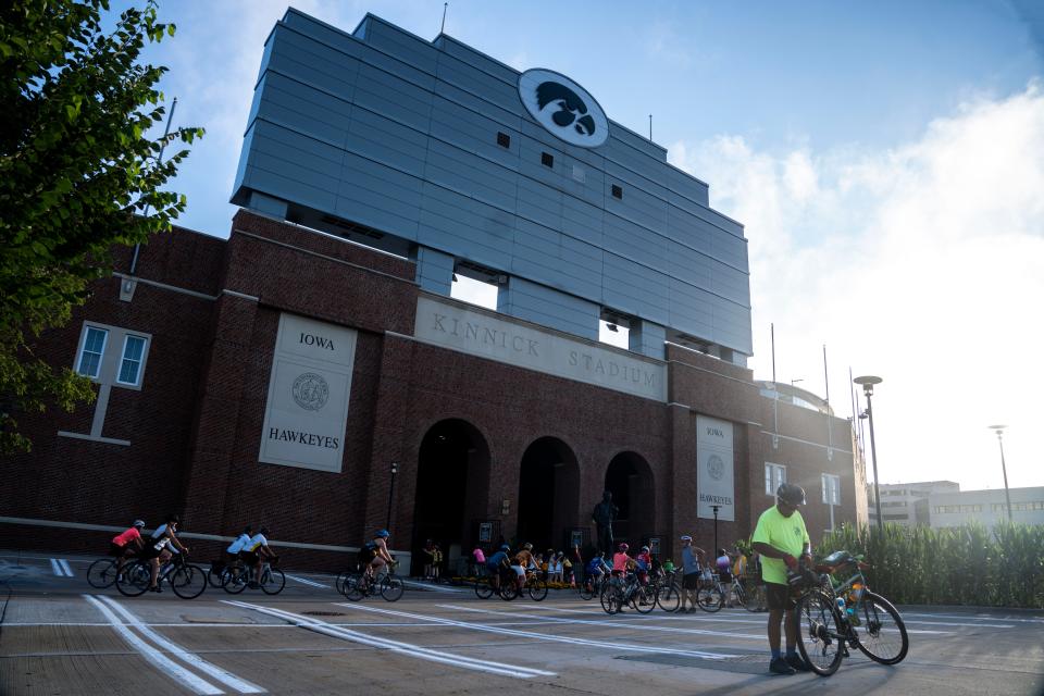 Cyclists roll through the University of Iowa's Kinnick Stadium on the final day of RAGBRAI 50 on Saturday in Iowa City.