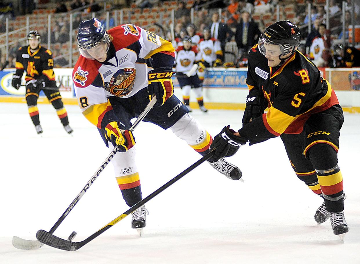 In this 2011 file photo, Erie Otters winger Connor Brown, left, fights for the puck with Belleville defenseman Jason Shaw, right, in the first period of their Thanksgiving night hockey game at the Tullio Arena in Erie.