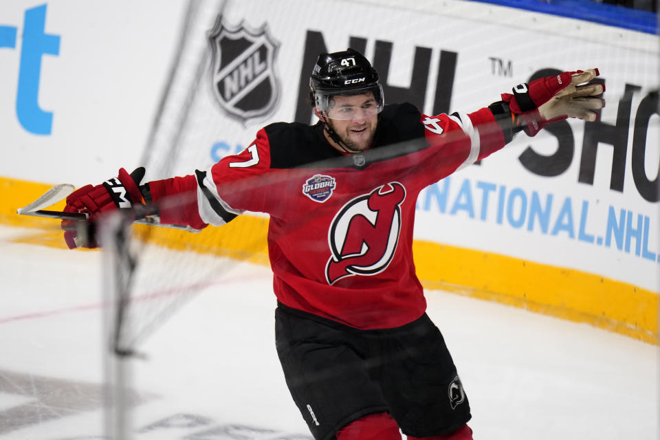 New Jersey Devils' Paul Cotter celebrates after scoring his sides second goal during the NHL hockey game between Buffalo Sabres and New Jersey Devils, in Prague, Czech Republic, Saturday, Oct. 5, 2024. (AP Photo/Petr David Josek)