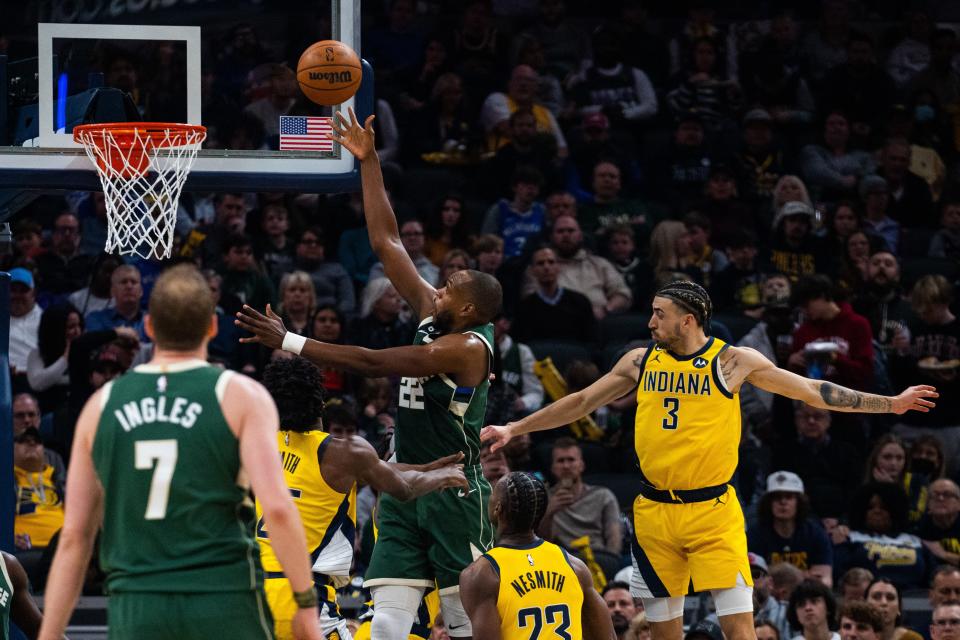 Bucks forward Khris Middleton goes up for a shot down low after driving past Pacers guard Chris Duarte (3) during the second quarter Friday night in Indianapolis.