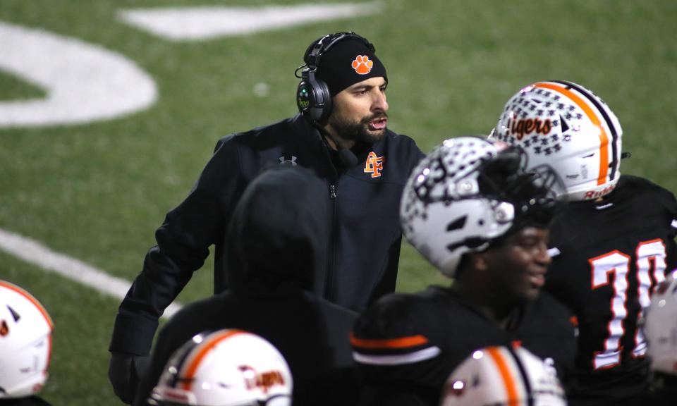 Beaver Falls Head Coach Nick Nardone talks to Damian Lee (70) during the second half of the WPIAL 2A Semifinals game against Sto-Rox Friday night at Ambridge Area High School.
