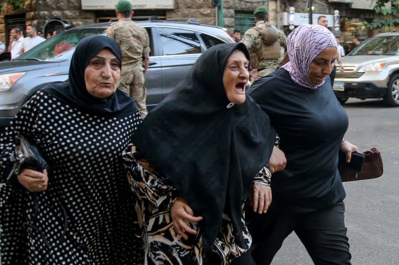 Women arrive to the American University hospital to check on their friends and family memebers. Eight people have been killed and some 2,750 injured in suspected coordinated explosions of hand-held telecommunications devices across Lebanon, Health Minister Firas Abiad said during a press conference in Beirut on 17 September. Marwan Naamani/dpa