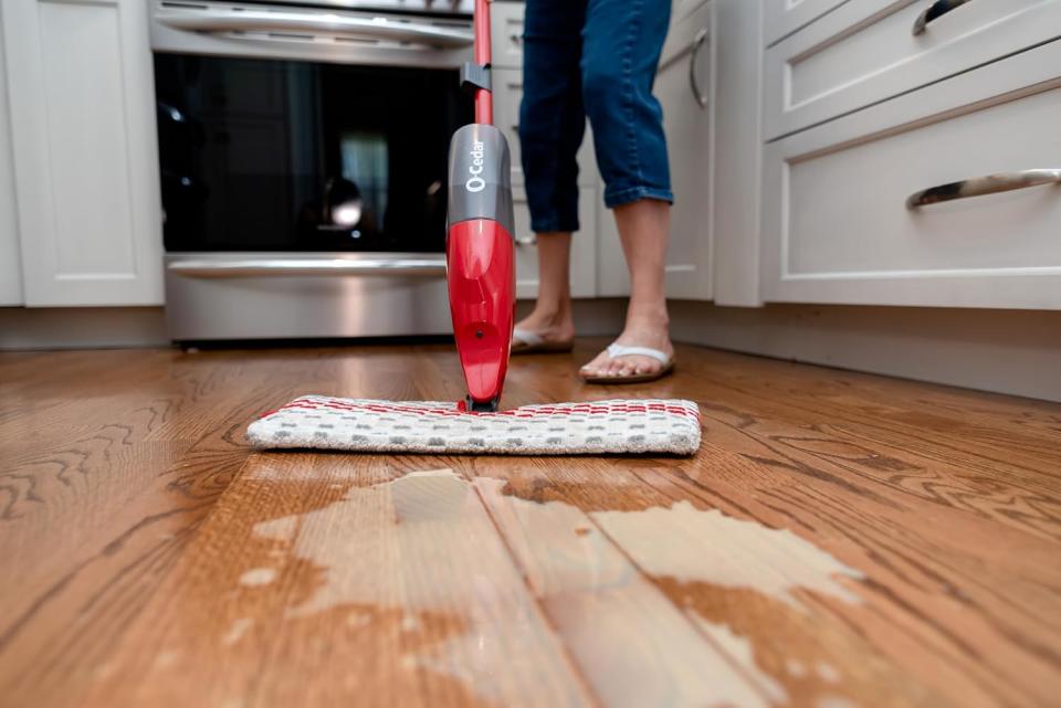 Woman mopping the floor with the ProMist.