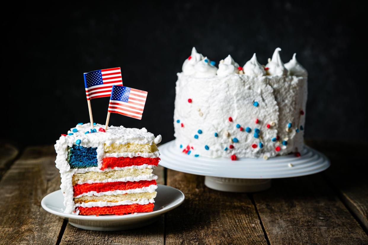 American national holidays concept - 4th of July, Memorial Day, Labour Day. Layered spounge cake in USA flag colours, rustic background, copy space