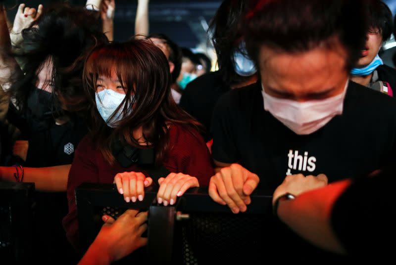 Fans wearing protective masks enjoy a band's performance at Hidden Agenda: This Town Needs (TNN) Live House during the club's last concert as business plummets due to the fear of the coronavirus, in Hong Kong