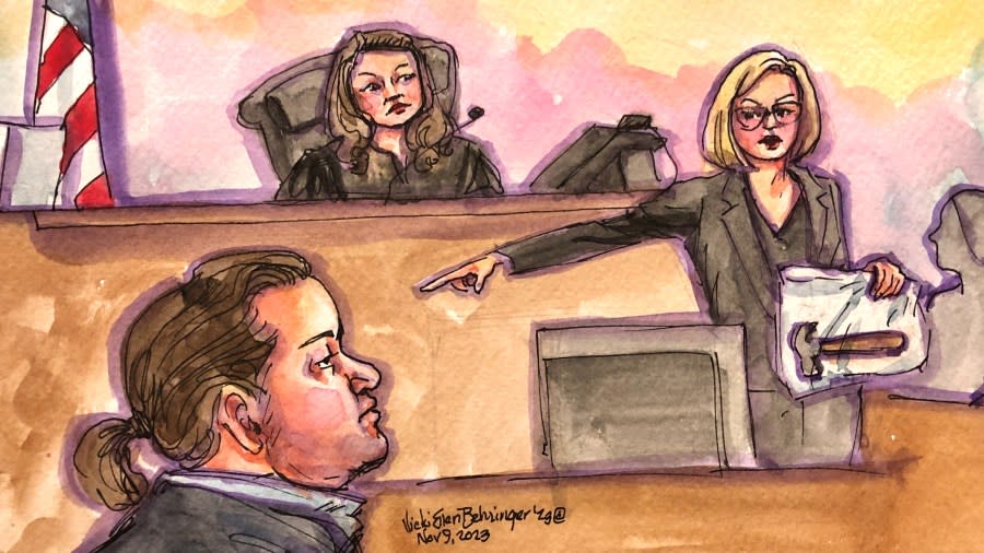 A prosecutor holds up a hammer and points to David DePape inside a federal courtroom in San Francisco. (Courtroom sketch by Vicki Behringer)