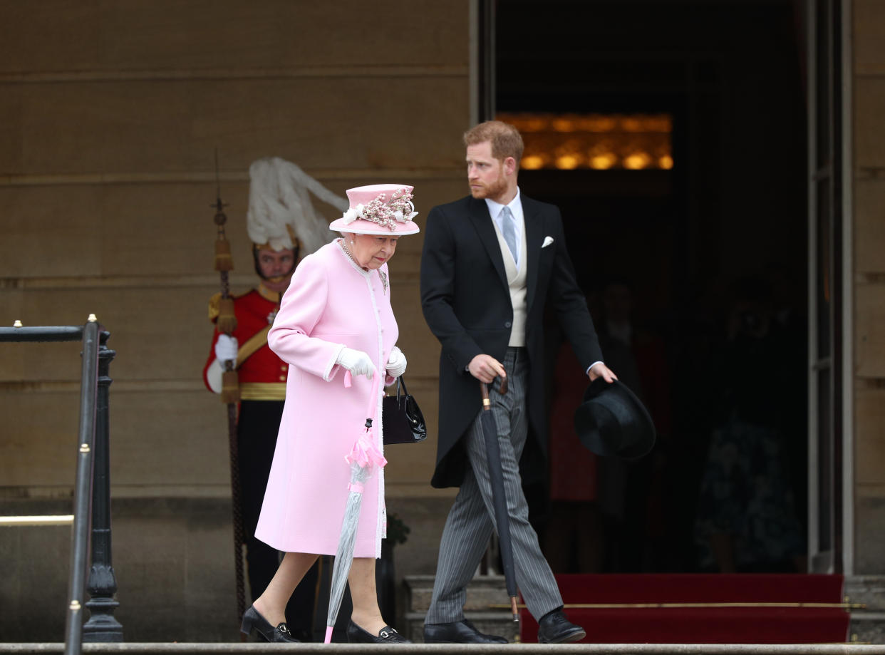 Britain's Queen Elizabeth II and Britain's Prince Harry, Duke of Sussex arrive at the Queen's Garden Party in Buckingham Palace, central London on May 29, 2019. (Photo by Yui Mok / POOL / AFP)        (Photo credit should read YUI MOK/AFP via Getty Images)
