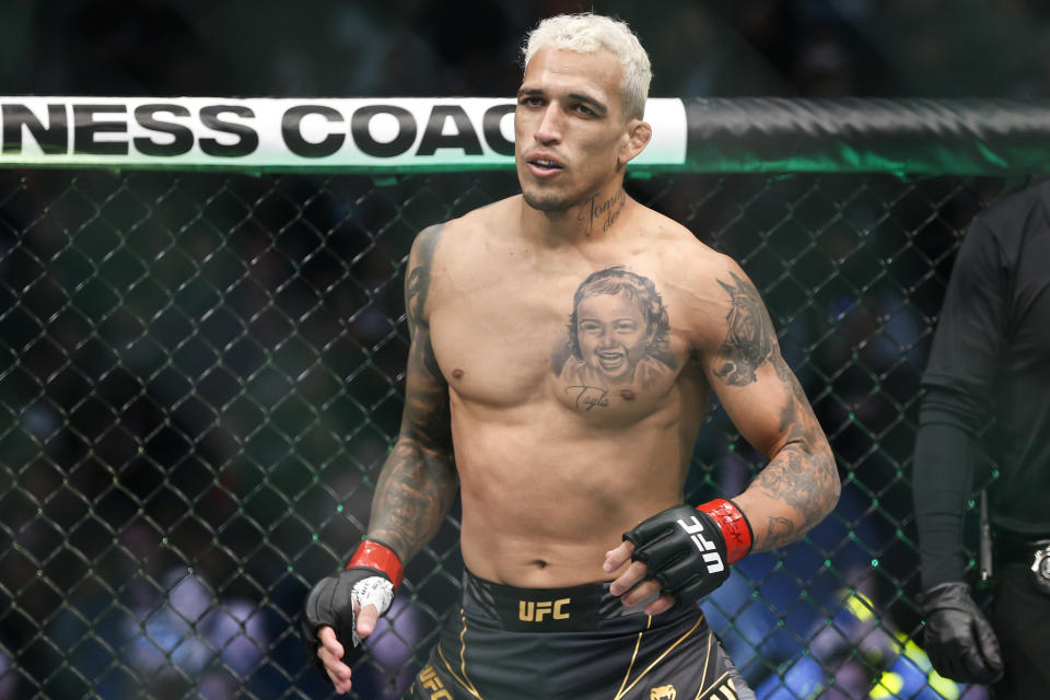 Charles Oliveira enters the octagon before a lightweight mixed martial arts title bout against Dustin Poirier at UFC 269, Saturday, Dec. 11, 2021, in Las Vegas. (AP Photo/Chase Stevens)