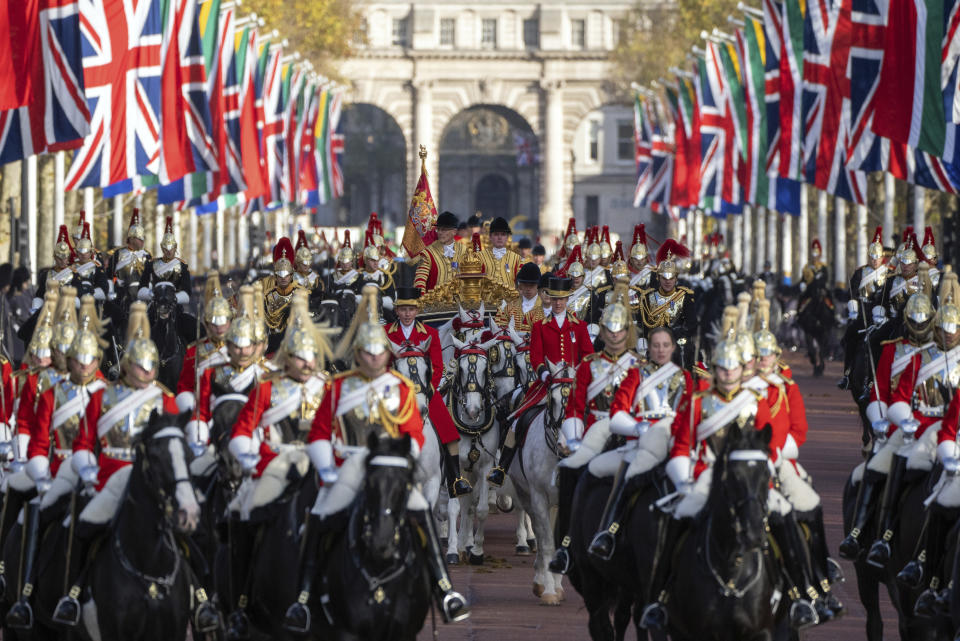 The State Carriage carrying Britain's King Charles III, Camilla, the Queen Consort and South African President Cyril Ramaphosa makes its way along The Mall toward Buckingham Palace, London, Tuesday Nov. 22, 2022, at the start of the president's two day state visit. (Carl Court/Pool via AP)