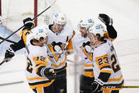 Pittsburgh Penguins' Kris Letang (58) celebrates with Brock McGinn (23), Evgeni Malkin (71) and Kasperi Kapanen (42) after scoring a goal during the second period of Game 5 of an NHL hockey Stanley Cup first-round playoff series against the New York Rangers Wednesday, May 11, 2022, in New York. (AP Photo/Frank Franklin II)