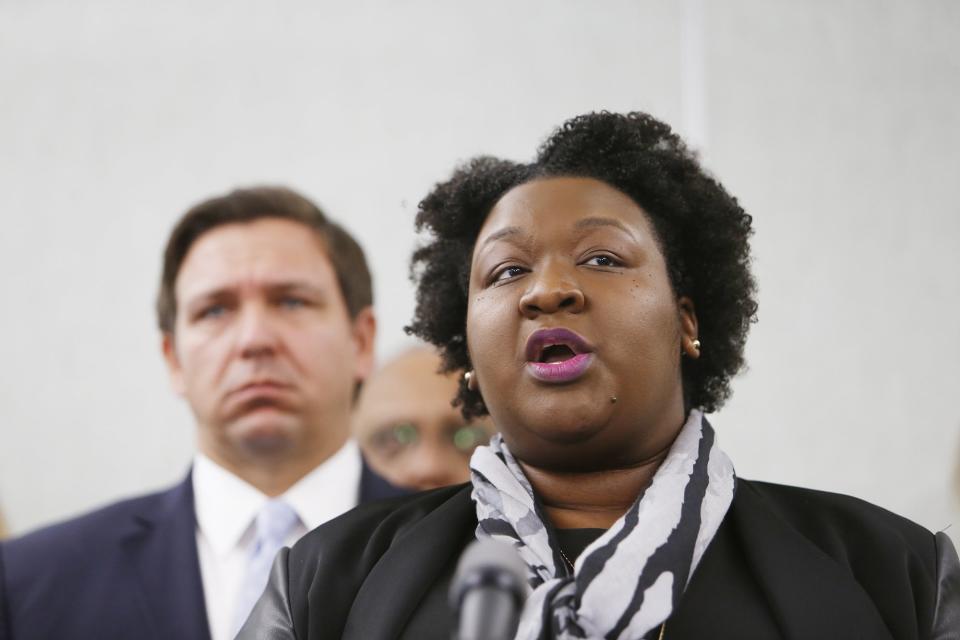 Florida Governor Ron DeSantis, left, looks on while Deputy Secretary for Health Dr. Shamarial Roberson, right, speaks about the confirmed coronavirus cases in Hillsborough and Manatee Counties while other local and state officials are in attendance during a press conference at the Florida Department of Health Laboratory in Tampa, Florida on March 2, 2020. (Octavio Jones/Tampa Bay Times via ZUMA Wire)