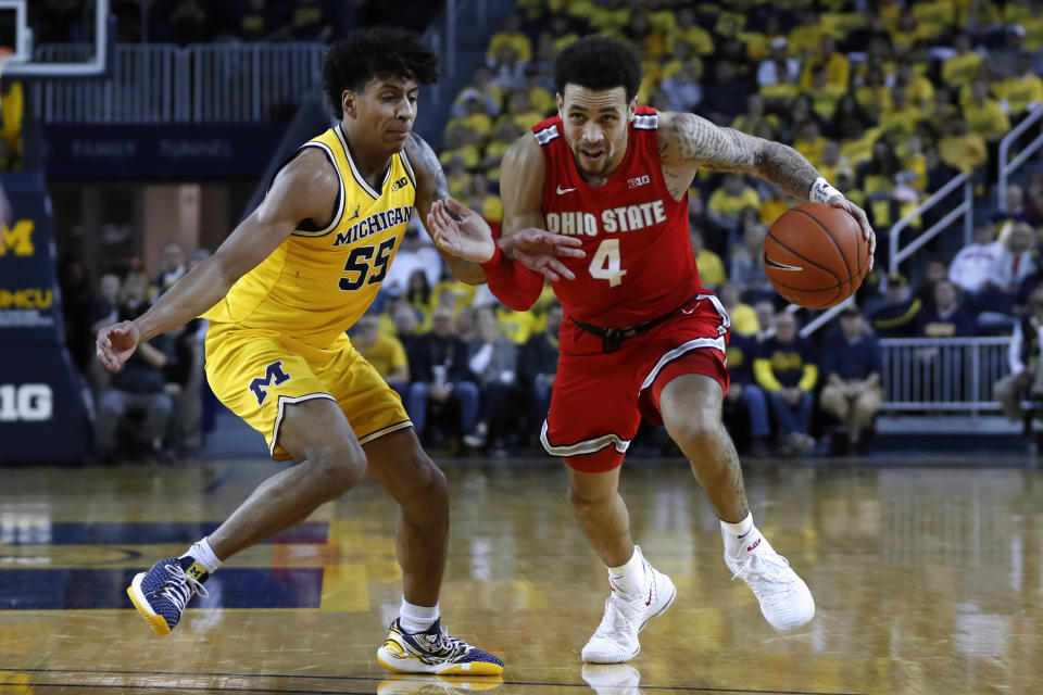 Ohio State guard Duane Washington Jr. (4) drives on Michigan guard Eli Brooks (55) in the first half of an NCAA college basketball game in Ann Arbor, Mich., Tuesday, Feb. 4, 2020. (AP Photo/Paul Sancya)