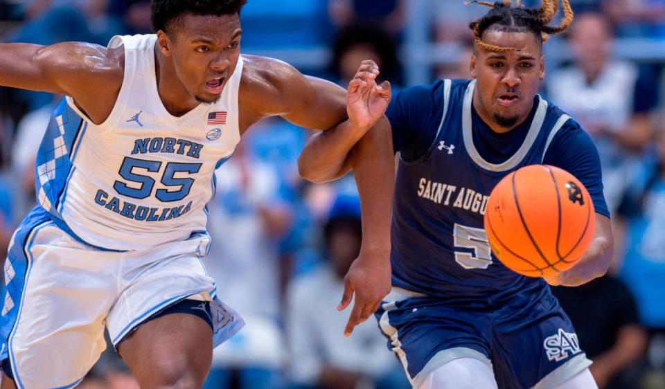 North Carolina’s Harrison Ingram (55) goes after the ball with St. Augustine’s Kaleb Glasser (5) in the first half on Friday, October 27, 2023 at the Smith Center in Chapel Hill, N.C.