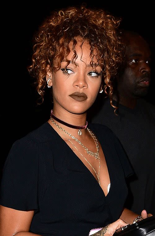 The singer looked gothic-chic at Travis Scott’s New York concert with a crazy curly high-top pony, big juicy dark chocolate lips, sultry cat eyes and some fine looking bling.