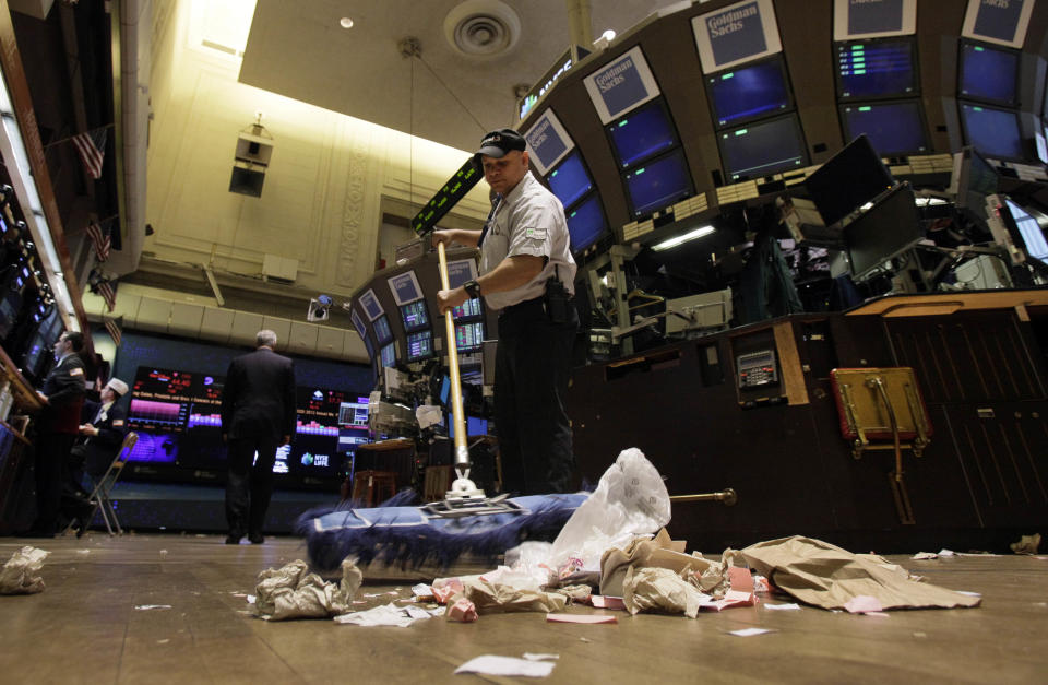 In this Friday, June 1, 2012, file photo, Raul Rodriguez sweeps the trading floor of the New York Stock Exchange. The global economy’s foundations are weakening, one by one. The global economy's foundations are weakening, one by one. Already hobbled by Europe's debt crisis, the world now risks being hurt by slowdowns in its economic powerhouses. (AP Photo/Richard Drew, File)