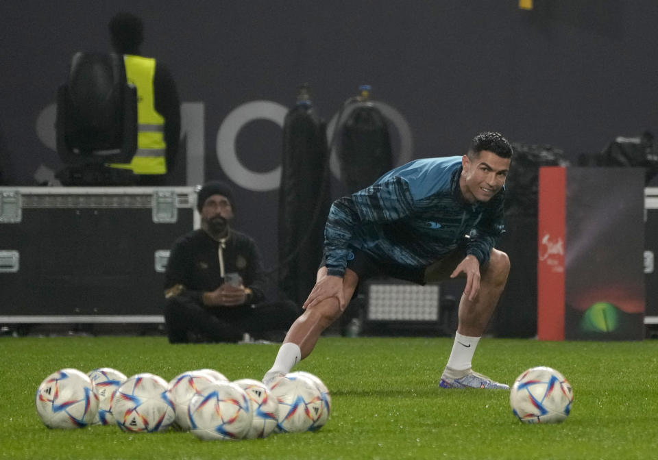FILE - Cristiano Ronaldo, warms up during his first training after the official unveiling as a new member of Al Nassr soccer club in in Riyadh, Saudi Arabia, on Jan. 3, 2023. Ronaldo is not the first soccer superstar to head off to one of the world’s supposed minor leagues in the latter years of his career. Many of soccer's biggest names like Pelé, Johan Cruyff, Zico, Xavi Hernandez and now the 37-year-old Ronaldo at Saudi Arabian club Al Nassr have found themselves prolonging their careers at unlikely soccer outposts usually for vast amounts of money. (AP Photo/Amr Nabil, File)