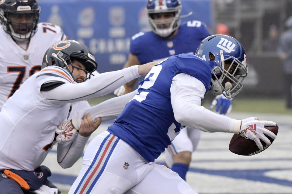 Chicago Bears quarterback Chase Daniel, left, tries to tackle New York Giants linebacker Alec Ogletree after Ogletree intercepted his pass and returned it for a touchdown. (AP)
