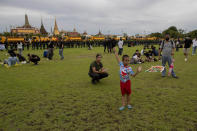 A child flies a kite during a pro-democracy rally at Sanam Luang in Bangkok, Thailand, Saturday, Sept. 19, 2020. Protesters gathered Saturday in Bangkok for the most ambitious rally so far in a pro-democracy campaign that has shaken up the government and the country's conservative establishment. (AP Photo/Gemunu Amarasinghe)