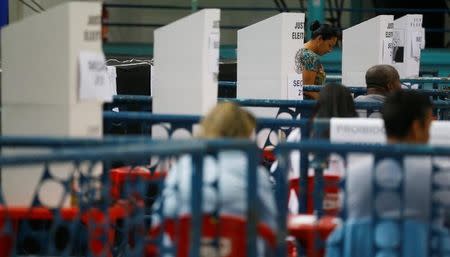 A woman votes during municipal elections at a polling station in Rio de Janeiro, Brazil, October 30, 2016. REUTERS/Ricardo Moraes