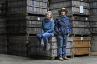 Gail Hepworth, right, and Amy Hepworth, sisters and co-owners of Hepworth Farms, pose for a picture in front of crates full of hemp plants at Hepworth Farms in Milton, N.Y., Monday, April 12, 2021. Farmers dealing with depressed prices for plants that produce CBD extract are eager to take part in a statewide marijuana market expected to generate billions of dollars a year once retail sales start. They already know how to grow and process cannabis plants, since hemp is essentially the same plant with lower levels of THC, marijuana's active ingredient. Now they're waiting on rules that will allow them to switch seeds. (AP Photo/Seth Wenig)