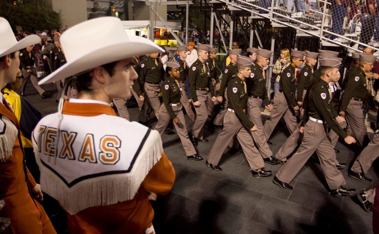 Texas A&M Corps of Cadets march past the Texas band before the Longhorns' game against Texas A&M game at Kyle Field in College Station on Nov. 24, 2011. The two rivals haven't played since then, but Texas will visit the Aggies on Nov. 30 in what is the priciest game to attend in the SEC this season.