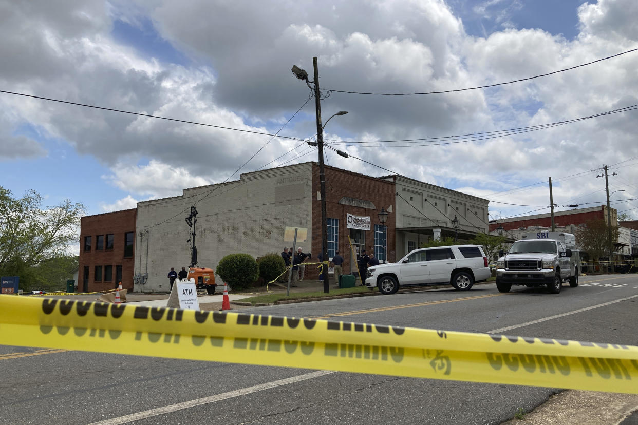 Investigators work at the site of a fatal shooting in downtown Dadeville, Ala., on Sunday, April 16, 2023. Several were killed during a shooting at a birthday party Saturday night, the Alabama Law Enforcement Agency said. (AP Photo/Jeff Amy)